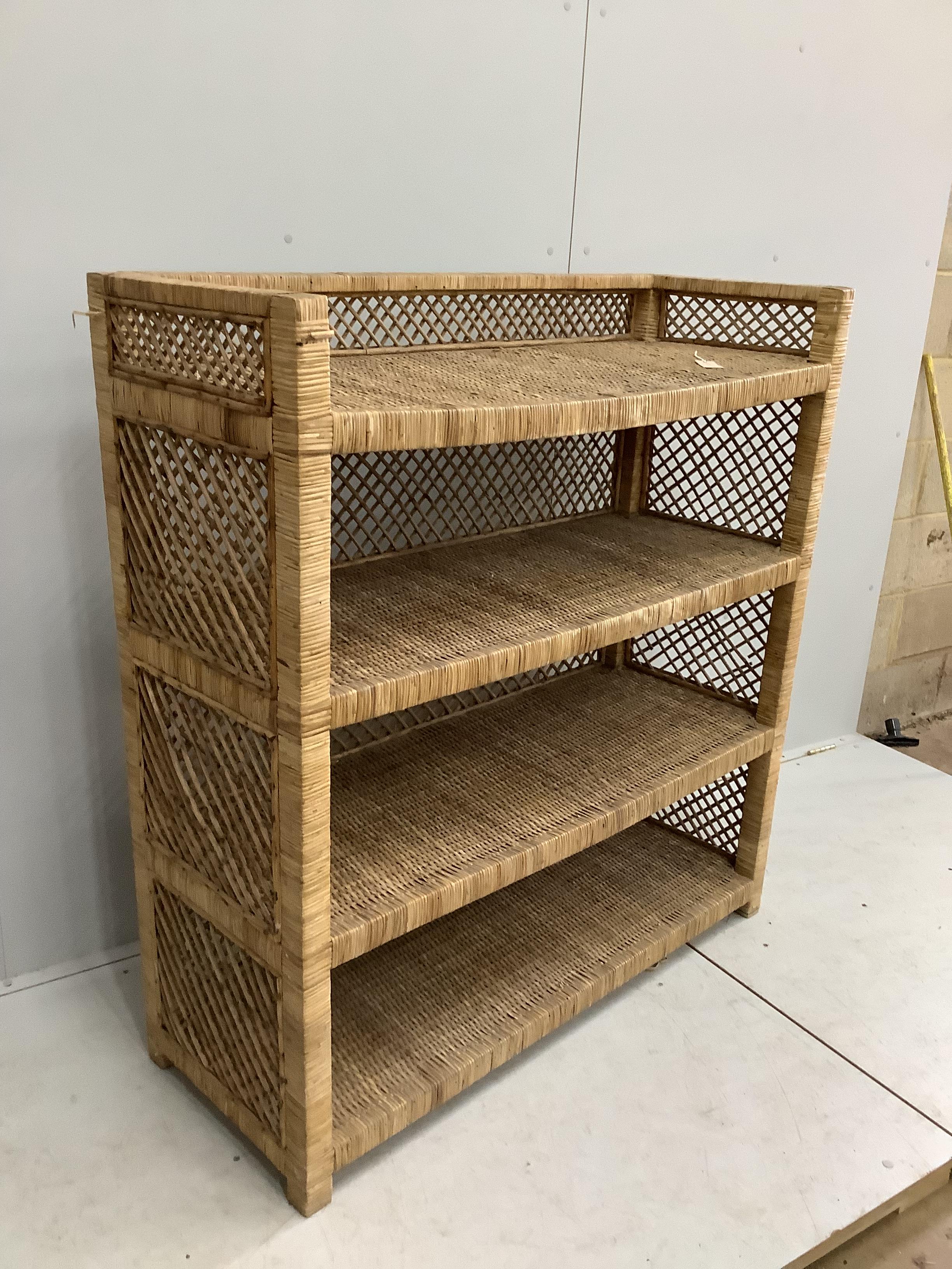 A wicker four tier shelving unit, width 121cm, depth 46cm, height 129cm